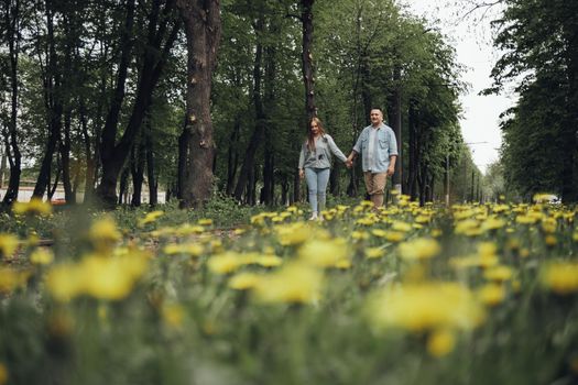 loving couple walking in ukrainian park and city