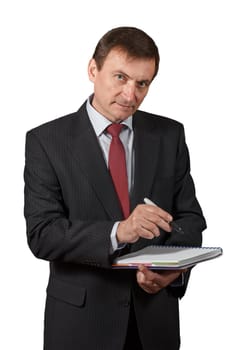 Confident and friendly elegant handsome mature businessman holding a marker and writing in a notebook on white isolated background