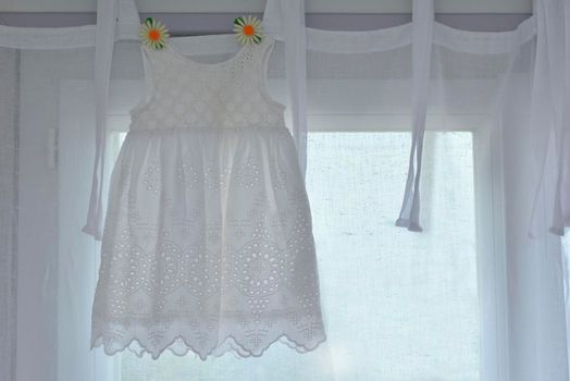 white dress for girl hanging for birthday celebration