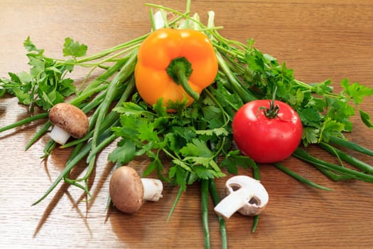 Set of good natural products with fresh pepper, tomato, mushrooms, onion and parsley on the table