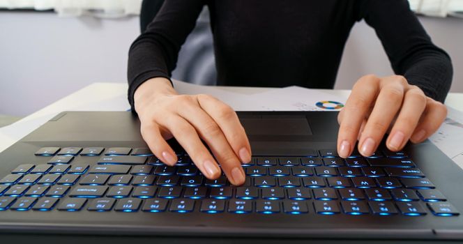 Female hands texting on laptop keyboard close up. Busy business woman emailing use digital wireless portable device. Office work, software, online education, apps, modern tech concept.