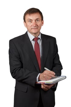 Confident and friendly elegant handsome mature businessman holding a marker and writing in a notebook on white isolated background