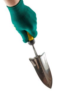 Small garden trowel in hand dressed in a green glove isolated on white