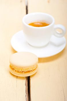 colorful macaroons with espresso coffee over white wood table