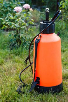 Fertilizer pesticide garden sprayer on lawn with green grass