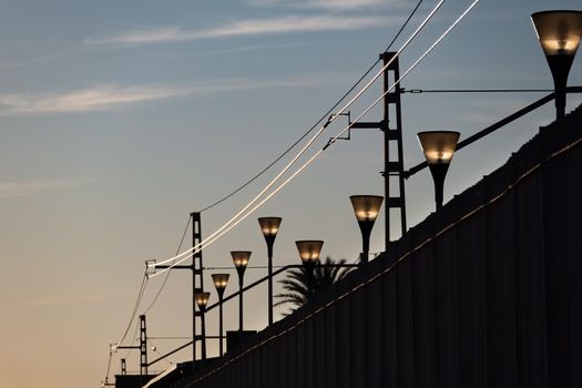 Lanterns of the railway station at the sunset.