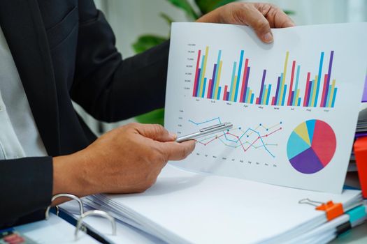 Businessman working and analysis with statistic graph in office. 