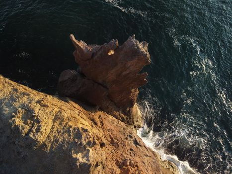 The rock or lava formation with the shape of a large animal or dragon head arise from the water. Popular travel destination volcanic rock formation in the shape of a dragon's head. Crimea, Fiolent