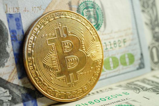 Golden bitcoin on US dollar banknotes money for business and commercial, Digital currency, Virtual cryptocurrency, blockchain technology.