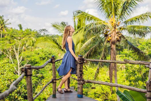 Young woman traveler on view point in the background of a jungle, Bali, Indonesia.