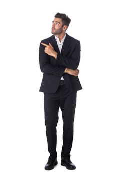Full body picture of a handsome young business man pointing to his side isolated on white background