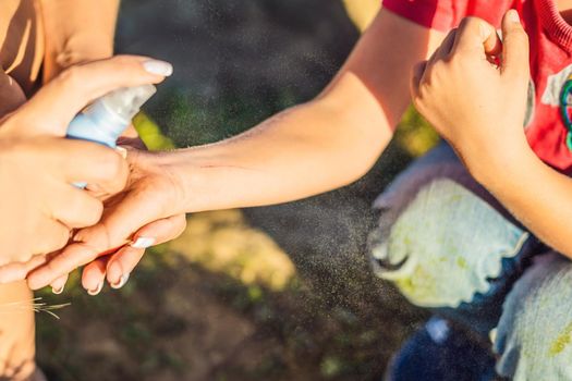 Mom uses the remedy against scratches and bruises. The boy has a scratch on his arm.