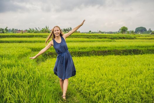Young woman on Green cascade rice field plantation. Bali, Indonesia.