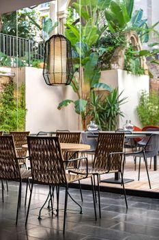 Restaurant tables with a patio or garden. Interior space of cafe in Spain.