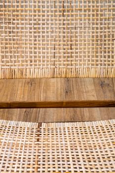 Detail of back part of modern wicker chair standing in a living room with laminate. Interior wooden furniture