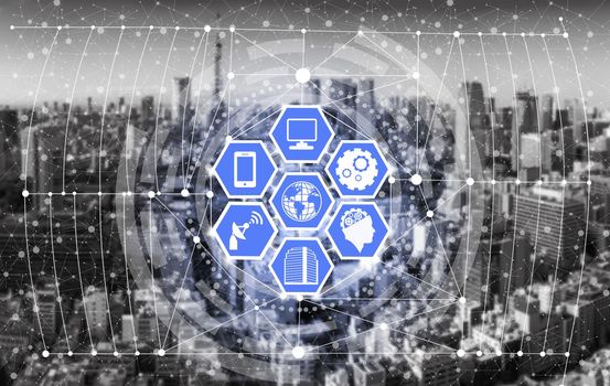 Smart city wireless communication network with graphic showing concept of internet of things ( IOT ) and information communication technology ( ICT ) against modern city buildings in the background.