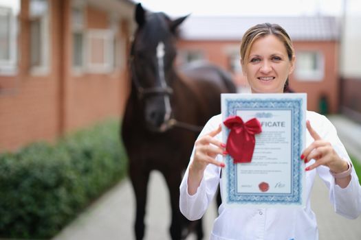 Veterinarian holds medical certificate for thoroughbred horse. Medicine survey of horses concept