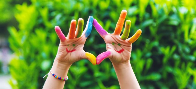 Children's hands in the colors of summer. Selective focus.arts