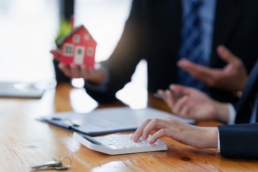 Close up Business woman or Real Estate agent explain signing agreement for buying house. Bank manager and real estate concept