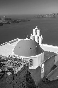 Three Bells of Fira in Santorini, Greece with blue sky in black and white