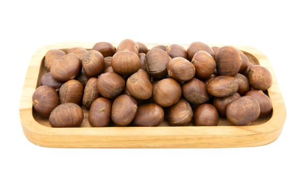 Roasted chesnuts in wooden tray isolated on white background