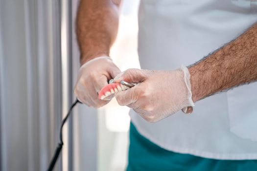 Grinding of the denture. Close-up