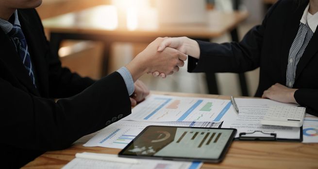 Two business people shake hands after accepting a business proposal together, a handshake is a universal homage, often used in greeting or congratulations