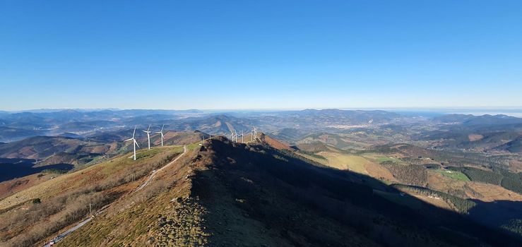 Wind turbines are located on top of the mountain which uses wind power as renewable energy. renewable environment concept design with copy space.