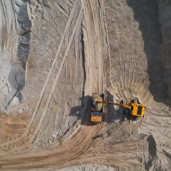 Aerial view of sand quarry with bulldozer.