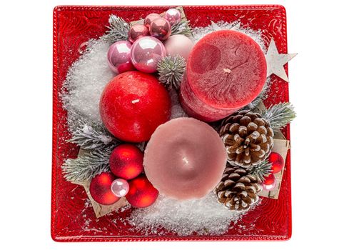 Holiday decoration with candles, cones and snow.Top view. Isolated on white