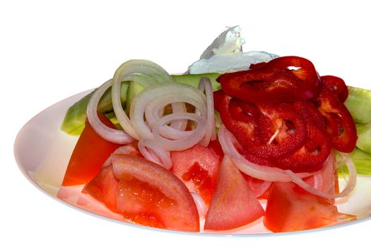 Traditional Greek salad. Tomatoes, sliced cucumbers, paprika, onion, cheese in a plate, isolated on white background. 