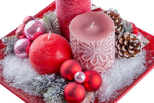 Holiday decoration with candles, cones and snow. Isolated on white