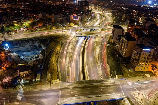 Beautiful night traffic junction road with lights of vehicle movement aerial view from drone