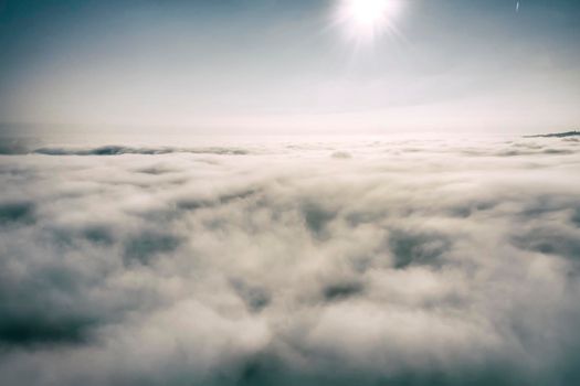 Aerial view white clouds in a blue sky. View from drone. Aerial bird's eye view. The texture of the clouds. View from above. Sunrise or sunset over clouds.