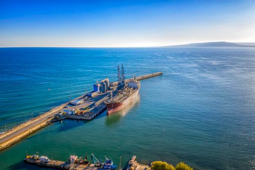 A tanker of the city port. Aerial view from a drone. Concept export ship