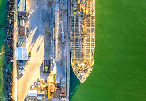 A part of a tanker of the city port. Aerial top view from a drone. Concept export ship