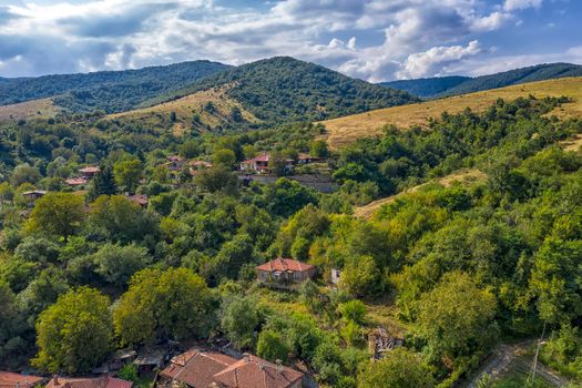 Panoramic Drone Aerial View view of mountain peaks. Hilltops covered with forest. Green nature background aerial view mountain landscape.
