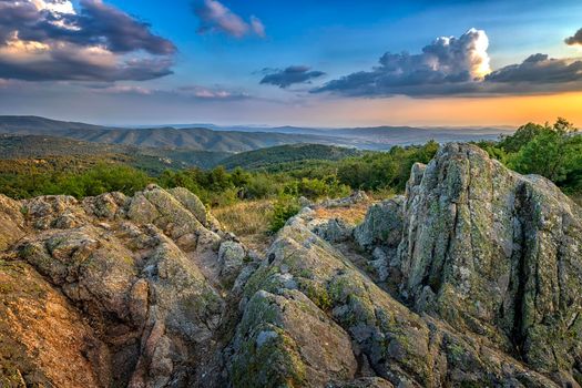 Amazing rocks on the edge of a mountain. Beautiful summer landscape  of mountains at sunset