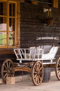 An empty antique carriage stands on a ranch in the wild West.