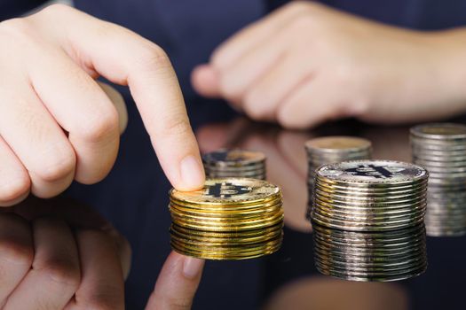 Close-up of finger touching golden bitcoin coin. Cryptocurrency and future money concept