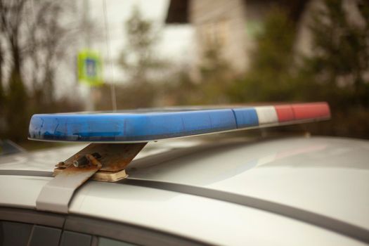 Police flasher on car. Details of police car. Blue and red signal on roof of vehicle.