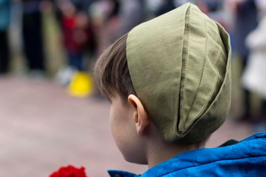 The baby is on May 9. Military hat cap. A child in an old military uniform. A commemorative day of the Second World War.