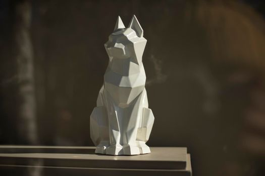 Figure of cat. Sculpture made of white plastic. Interior details. Item for decoration.