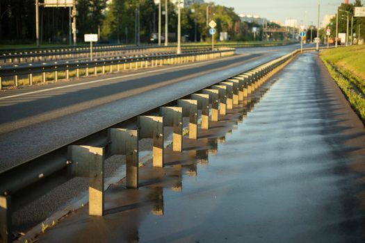 Washed road. Road bumper. Design to protect pedestrians. Fence for cars. Place of passage. Pedestrian area. After wet highway cleanup.