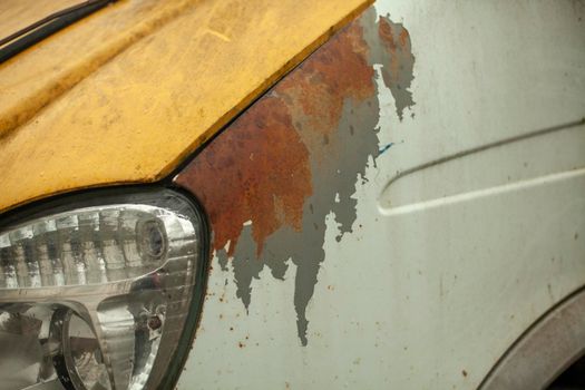 Car lamp. Rusty surface of machine. Old transport. Details of average truck in Russia.