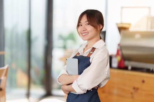 Asian Barista cafe owner smile while cafe open. SME entrepreneur seller business concept