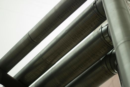 Heating pipes. Urban communications. Stainless steel pipes. Details of industrial architecture.