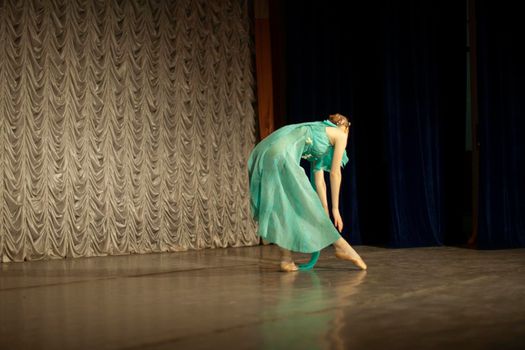 Ballerina dances. Dance lesson on stage. Girl in dress. Beautiful movement.