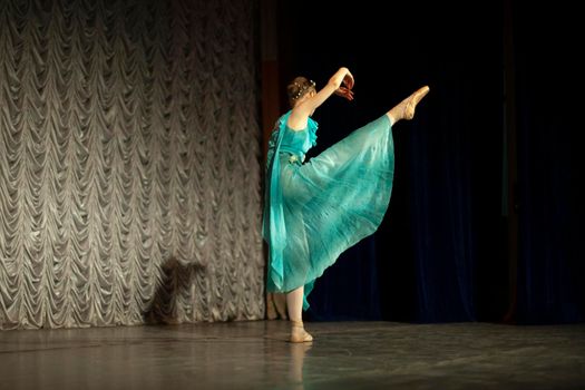 Ballerina dances. Dance lesson on stage. Girl in dress. Beautiful movement.