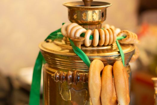 Samovar in Russia. Kettle for tea drinking. Bagels on rope. Traditions of drinking tea among Russians.